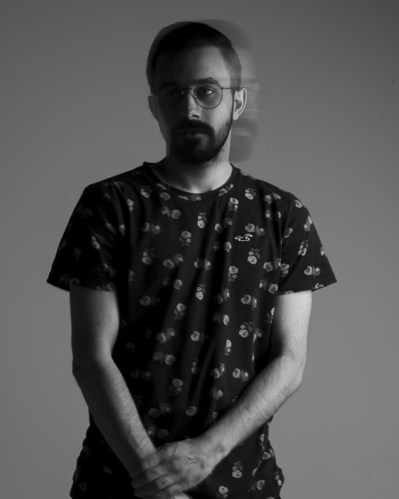 Black-and-white self-portrait, standing